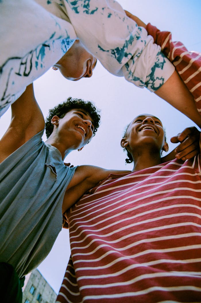 The Art of Drawing Readers In: Your attractive post title goes here Happy group of teenagers enjoying a moment together under blue sky, symbolizing friendship and fun.
